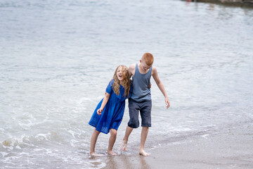 boy and girl playing with waves