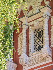 The window of the old Orthodox church in the Baroque style is decorated with stone carvings