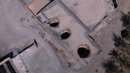 Ancient Water Wells and Ruins in Desert Landscape – Aerial View of Historical Site