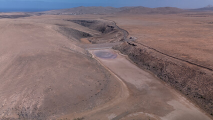 Aerial View of Desert Reservoir and Dam Structure in Arid Mountainous Landscape