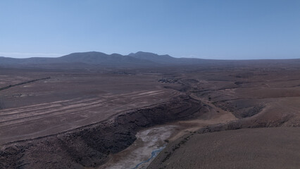 Aerial View of Desert Reservoir and Dam Structure in Arid Mountainous Landscape