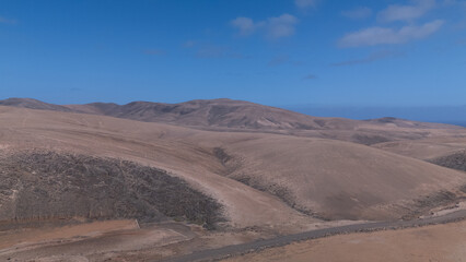 Desert Track Through Volcanic Hills Under Clear Sky – Remote Arid Landscape