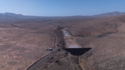 Aerial View of Desert Reservoir and Dam Structure in Arid Mountainous Landscape