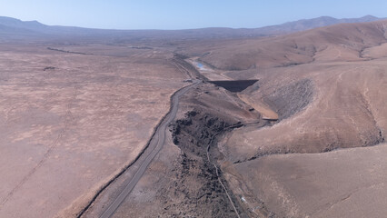 Aerial View of Desert Reservoir and Dam Structure in Arid Mountainous Landscape