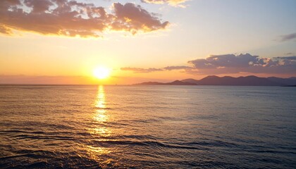 Obraz premium Sunset over calm ocean waters