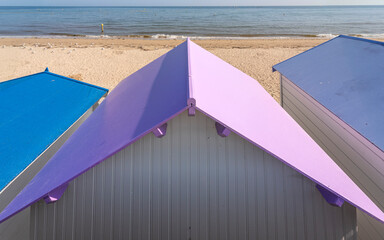 Langrune-Sur-Mer, France - 08 11 2025:  Detail view of decorated beach cabins with colorful roofs,...