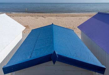 Langrune-Sur-Mer, France - 08 11 2025:  Detail view of decorated beach cabins with colorful roofs,...