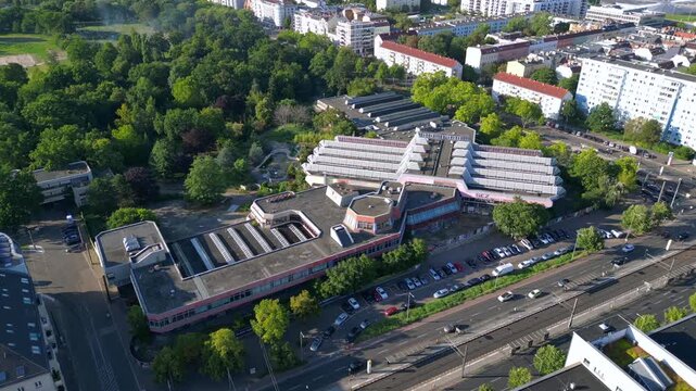 Sez and Volkspark Friedrichshain in Berlin, showcasing its lush greenery, a passing tram on a sunny day. speed ramp hyper motion time lapse Lovely aerial view flight panorama orbit drone