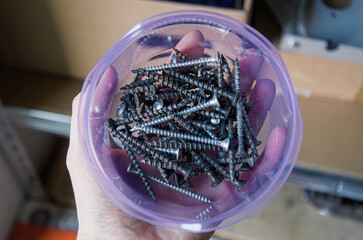 Screw storage container on workshop workspace