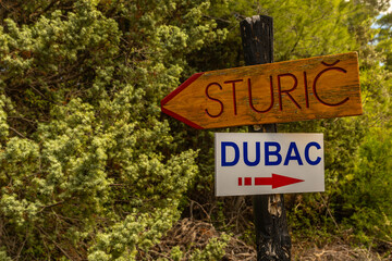 A sign informing about the trail leading to the wild beach of Dubac Strucic on the island of Rab