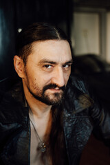 Fototapeta premium portrait of a handsome man with dark hair and a black beard