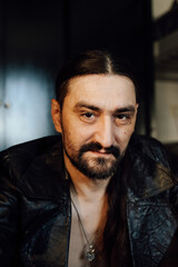 Fototapeta premium portrait of a handsome man with dark hair and a black beard