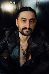 Fototapeta premium portrait of a handsome man with dark hair and a black beard