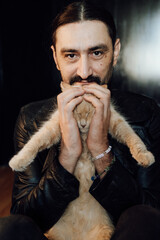 portrait of a handsome man with dark hair and a black beard