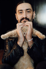 portrait of a handsome man with dark hair and a black beard