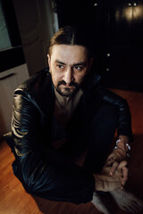 portrait of a handsome man with dark hair and a black beard