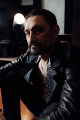 portrait of a handsome man with dark hair and a black beard
