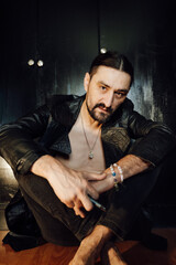 portrait of a handsome man with dark hair and a black beard