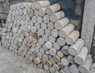Stack of concrete cylinder test specimens used in laboratory for compressive strength evaluation in...