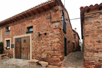 Rustic Stone House, Castrillo, Spain: a traditional reddish-stone house on a cobblestone street in...