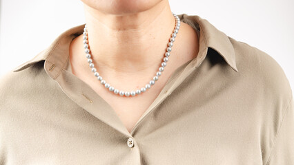 Young woman wearing stylish jewelry on white background closeup