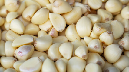 Heap of peeled garlic cloves sold at traditional market
