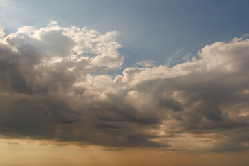 Dramatic clouds forming in blue evening sky