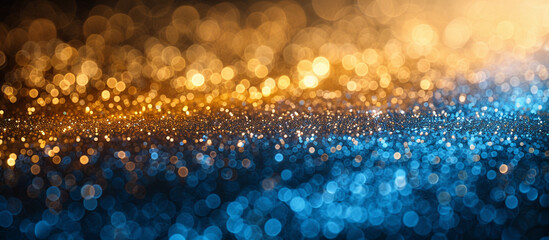 Abstract bokeh background with gold and blue glitter.