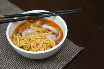 Northern Thai food Khao Soi, a spicy Thai dish consisting of noodles and a delicious curry and...