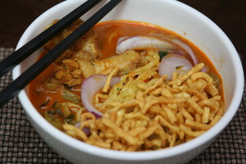 Northern Thai food Khao Soi, a spicy Thai dish consisting of noodles and a delicious curry and...