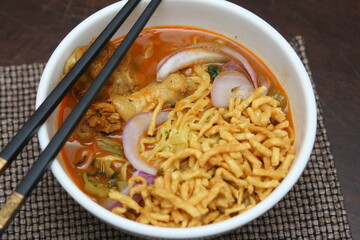 Northern Thai food Khao Soi, a spicy Thai dish consisting of noodles and a delicious curry and...