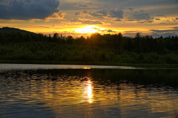 Sunset over a forest lake.