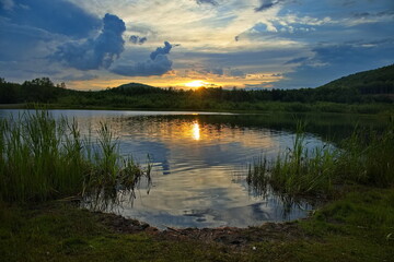 Sunset over a forest lake.