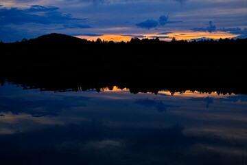 Sunset over a forest lake.