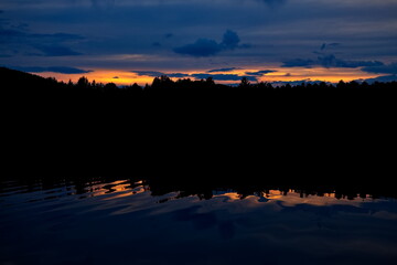 Sunset over a forest lake.