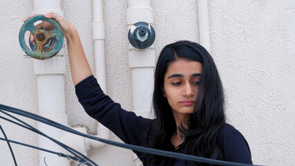 A young girl strikes a bold attitude pose, her confident expression reflecting strength, style, and...