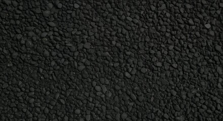 Fototapeta premium Close-up texture of black gravel stones, dark crushed rock surface background, perfect for construction, architecture, flooring, and natural abstract design concepts