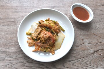 fried seafood with chicken and pork meat couple glass noodles vegetable toping egg yolk dipping...