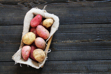 Fresh Young potatoes on a wooden background