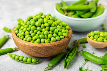 Fresh green pea pods with green peas on a wooden background. Sweet green peas. Green pea beans vegetables. Vegan. healthy vegetable. Copy space