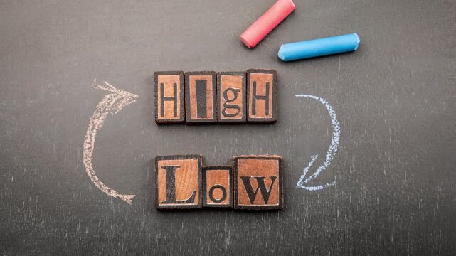 Conceptual image with wooden letter blocks spelling high and low, surrounded by red and blue chalk arrows