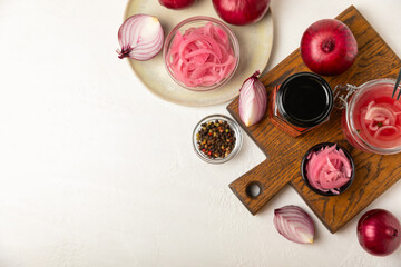 Pickled onions in a glass jar on the table. pickled red onion. Vegetarian spicy dish. Delicious homemade marinated pickled purple onions . Space for text. Copy space.