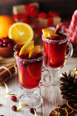 Glasses with warm cranberry with oranges drinks