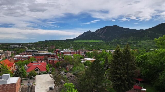 Front range college town of University of Boulder Colorado Chautauqua Park Flatirons aerial drone summer spring Green mountain Pearl Street Mall Eben G Fine Boulder creek blue sky sunny upwards motion