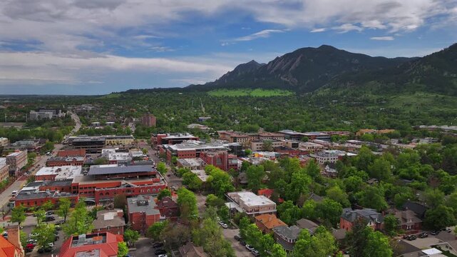 Front range college town of University of Boulder Colorado Chautauqua Park Flatirons aerial drone summer spring Green mountain Pearl Street Mall Eben G Fine Boulder creek blue sky sunny forward pan