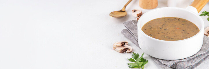Delicious tasty champignons mushrooms cream soup. Creamy pureed vegetable soup with mushrooms, carrot, herbs. Autumn and winter comfort food, vegan diet recipe