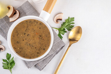 Delicious tasty champignons mushrooms cream soup. Creamy pureed vegetable soup with mushrooms, carrot, herbs. Autumn and winter comfort food, vegan diet recipe