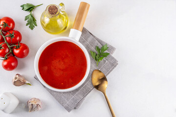 Tasty tomato cream soup. Delicious hot fall season gazpacho creamy pureed soup with garlic and aromatic herbs. Autumn and winter comfort food, tasty vegan vegetable recipe