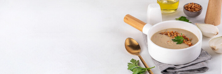 Cream of onion soup puree. White onion cream soup with crunchy caramelized fried onion topping. Autumn and winter comfort food, tasty vegan vegetable recipe