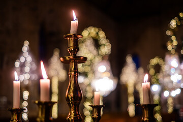 Elegant candle arrangement in a dimly lit setting, creating a serene atmosphere for remembrance and reflection during a funeral or memorial service